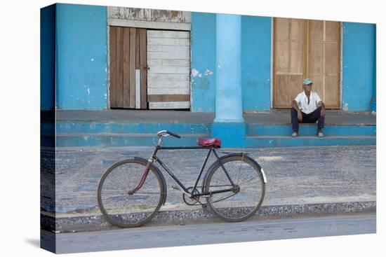 Old Bicycle Propped Up Outside Old Building with Local Man on Steps-Lee Frost-Stretched Canvas