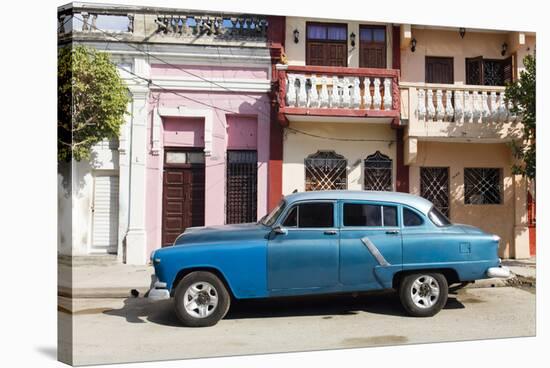 Old blue American car parked in front of old buildings, Cienfuegos, Cuba-Ed Hasler-Stretched Canvas