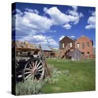 Old Farm Wagon and Derelict Wooden and Brick Houses at Bodie Ghost Town, California, USA-Tony Gervis-Stretched Canvas
