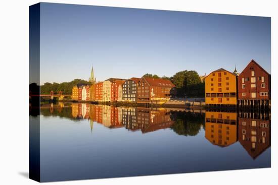 Old Fishing Warehouses Reflected in the River Nidelva-Doug Pearson-Stretched Canvas