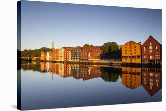 Old Fishing Warehouses Reflected in the River Nidelva-Doug Pearson-Stretched Canvas
