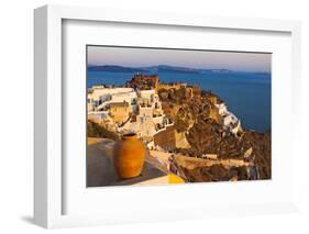 Old fortress and houses on the coast of Aegean Sea. Oia, Santorini Island, Greece.-Keren Su-Framed Photographic Print