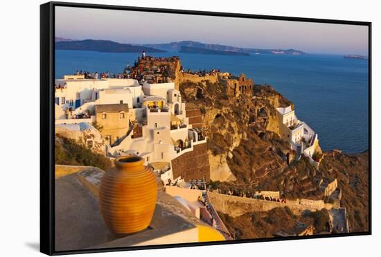 Old fortress and houses on the coast of Aegean Sea. Oia, Santorini Island, Greece.-Keren Su-Framed Stretched Canvas