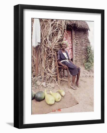 Old Haitian Woman in Front of Her Hut-Lynn Pelham-Framed Photographic Print