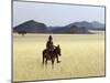 Old Himba Woman, Upright Despite Her Years, Rides Her Donkey Through Harsh Land-Nigel Pavitt-Mounted Photographic Print