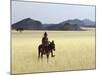 Old Himba Woman, Upright Despite Her Years, Rides Her Donkey Through Harsh Land-Nigel Pavitt-Mounted Photographic Print