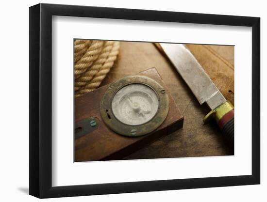 Old Knife, Compass, and Rope on a Old Wooden Desk, Exploration, Survival, and Hunting Concept Image-landio-Framed Photographic Print