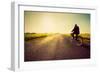 Old Man Riding A Bike On Asphalt Road Towards The Sunny Sunset Sky-Michal Bednarek-Framed Art Print