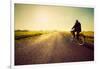 Old Man Riding A Bike On Asphalt Road Towards The Sunny Sunset Sky-Michal Bednarek-Framed Art Print