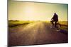 Old Man Riding A Bike On Asphalt Road Towards The Sunny Sunset Sky-Michal Bednarek-Mounted Premium Giclee Print