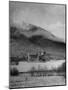 Old Scottish Castle Standing on a River Peninsula, with Mountain Rising in Background-Nat Farbman-Mounted Photographic Print