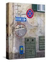 Old town house and traffic signs. Predazzo in valley Val di Fiemme, in the Dolomites Italy.-Martin Zwick-Stretched Canvas