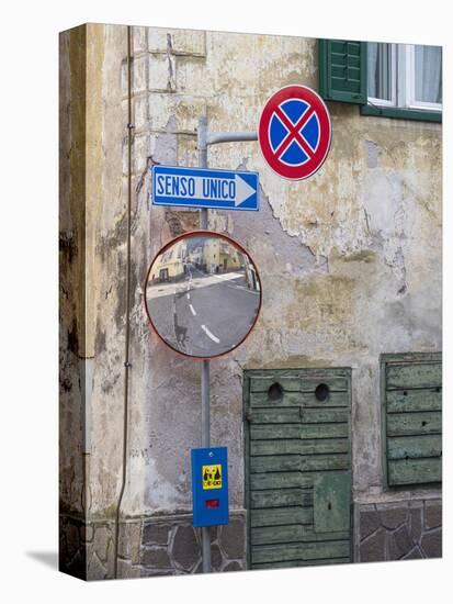 Old town house and traffic signs. Predazzo in valley Val di Fiemme, in the Dolomites Italy.-Martin Zwick-Stretched Canvas