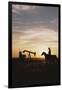 Old West, New West, Man Sitting on Horse with Oil Refinery at Sunset-David R^ Frazier-Framed Photographic Print