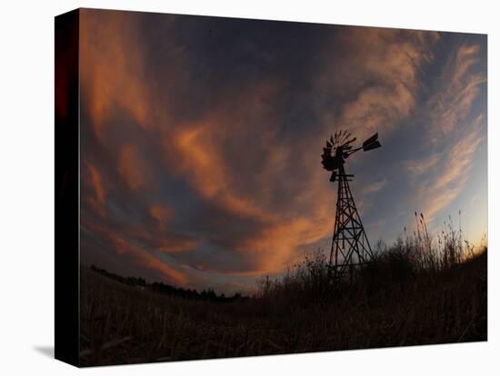 Old Windmill Silhouetted Against Clouds Colored by the Setting Sun-null-Stretched Canvas