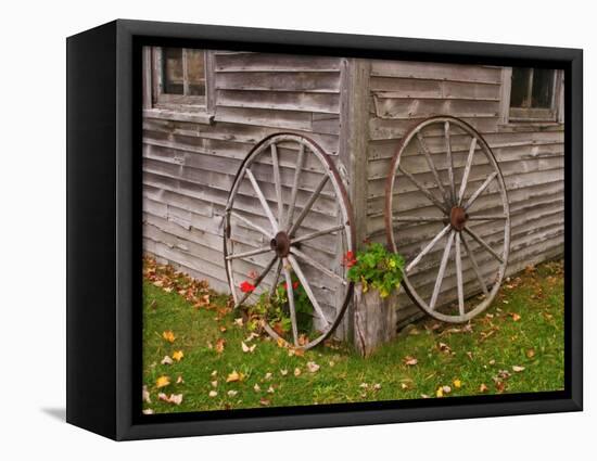 Old Wooden Barn with Wagon Wheels in Rural New England, Maine, USA-Joanne Wells-Framed Stretched Canvas