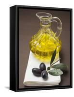 Olive Sprig with Black Olives, Carafe of Olive Oil Behind-null-Framed Stretched Canvas