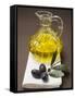 Olive Sprig with Black Olives, Carafe of Olive Oil Behind-null-Framed Stretched Canvas