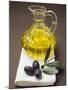 Olive Sprig with Black Olives, Carafe of Olive Oil Behind-null-Mounted Photographic Print