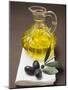 Olive Sprig with Black Olives, Carafe of Olive Oil Behind-null-Mounted Photographic Print