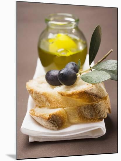 Olive Sprig with Black Olives on White Bread, Olive Oil Behind-null-Mounted Photographic Print