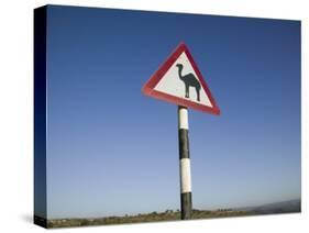 Oman, Dhofar Region, Salalah, Camel Crossing Sign in the Dhofar Mountains-Walter Bibikow-Stretched Canvas