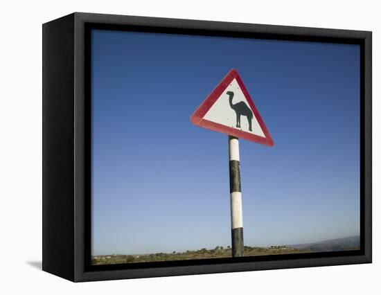 Oman, Dhofar Region, Salalah, Camel Crossing Sign in the Dhofar Mountains-Walter Bibikow-Framed Stretched Canvas