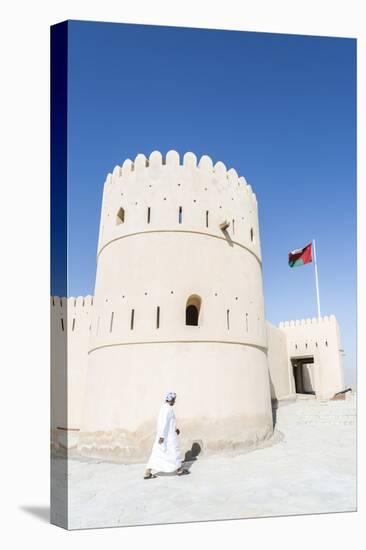 Oman, Sur. Omani Man Walking to the Entrance of Sunaysilah Old Fortress-Matteo Colombo-Stretched Canvas