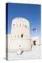 Oman, Sur. Omani Man Walking to the Entrance of Sunaysilah Old Fortress-Matteo Colombo-Stretched Canvas