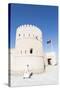 Oman, Sur. Omani Man Walking to the Entrance of Sunaysilah Old Fortress-Matteo Colombo-Stretched Canvas