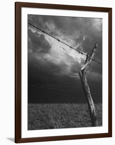 On a Small Farm, Ominous Clouds Overhead, Outlined by Barbed Wire Fencing-Nat Farbman-Framed Photographic Print