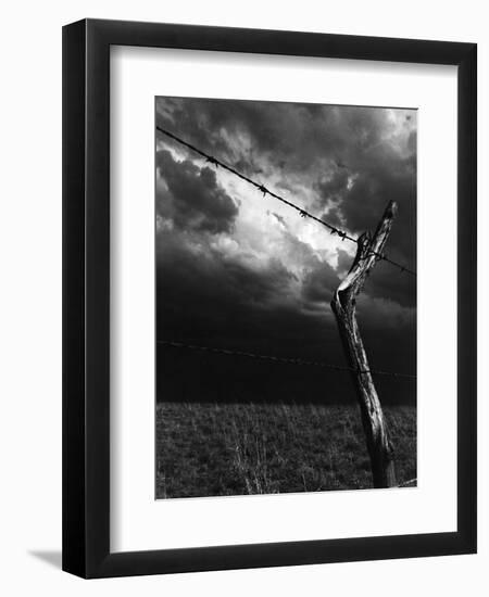 On a Small Farm, Ominous Clouds Overhead, Outlined by Barbed Wire Fencing-Nat Farbman-Framed Photographic Print