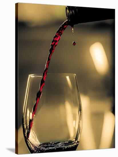 One drop shows as red wine is poured into glass.-Richard Duval-Stretched Canvas