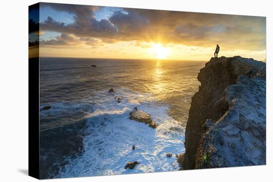 One man watching sunrise over the ocean waves from cliffs, Madeira island, Portugal, Atlantic-Roberto Moiola-Stretched Canvas