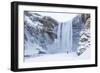 One Person in Red Jacket Walking in the Snow Towards Skogafoss Waterfall in Winter-Neale Clark-Framed Photographic Print