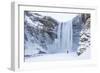 One Person in Red Jacket Walking in the Snow Towards Skogafoss Waterfall in Winter-Neale Clark-Framed Photographic Print