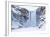 One Person in Red Jacket Walking in the Snow Towards Skogafoss Waterfall in Winter-Neale Clark-Framed Photographic Print