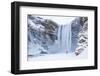 One Person in Red Jacket Walking in the Snow Towards Skogafoss Waterfall in Winter-Neale Clark-Framed Photographic Print