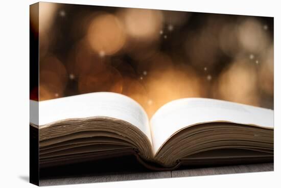 Open Book on Wooden Table with Bokeh Effect in the Background-Chris_Elwell-Stretched Canvas