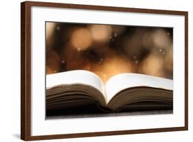 Open Book on Wooden Table with Bokeh Effect in the Background-Chris_Elwell-Framed Photographic Print
