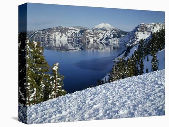 OR, Crater Lake NP. Evening light warms snowy rim of Crater Lake in late afternoon-John Barger-Stretched Canvas