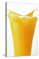 Orange Juice Splashing Out of Glass-Foodcollection-Stretched Canvas
