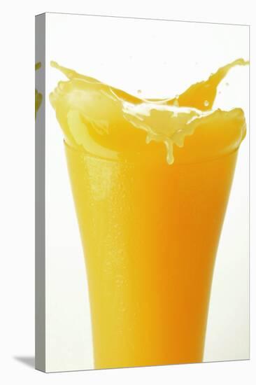 Orange Juice Splashing Out of Glass-Foodcollection-Stretched Canvas