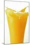 Orange Juice Splashing Out of Glass-Foodcollection-Mounted Photographic Print
