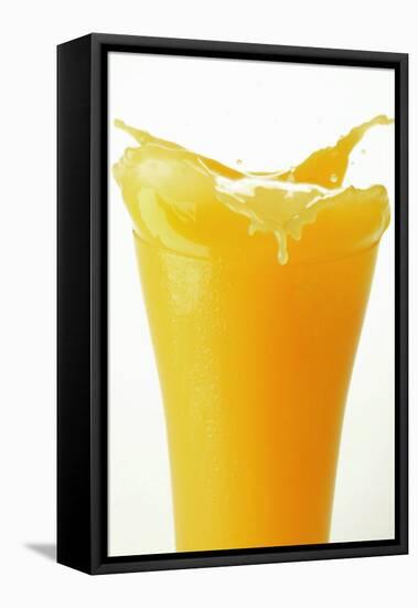 Orange Juice Splashing Out of Glass-Foodcollection-Framed Stretched Canvas