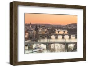 Orange sky at sunset on the historical bridges and buildings reflected on Vltava River, Prague, Cze-Roberto Moiola-Framed Photographic Print