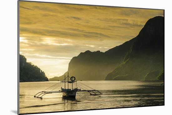 Outrigger at Sunset in the Bay of El Nido, Bacuit Archipelago, Palawan, Philippines-Michael Runkel-Mounted Photographic Print