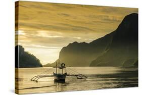 Outrigger at Sunset in the Bay of El Nido, Bacuit Archipelago, Palawan, Philippines-Michael Runkel-Stretched Canvas