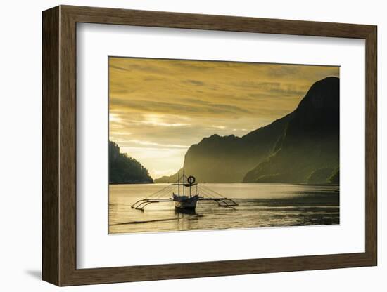 Outrigger at Sunset in the Bay of El Nido, Bacuit Archipelago, Palawan, Philippines-Michael Runkel-Framed Photographic Print