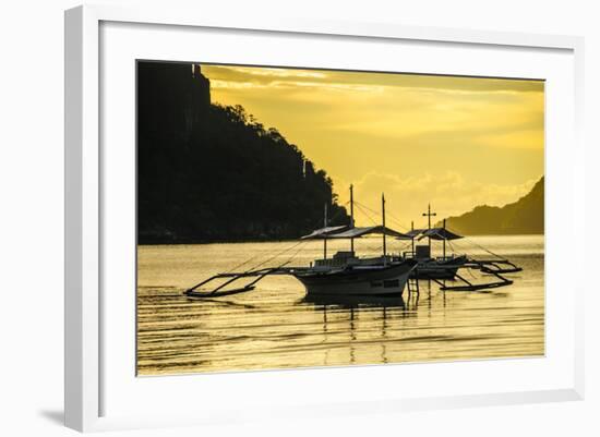 Outrigger at Sunset in the Bay of El Nido, Bacuit Archipelago, Palawan, Philippines-Michael Runkel-Framed Photographic Print